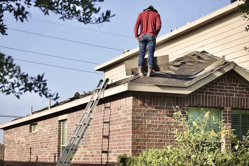 Professional roofer working on a residential roof in North Adams